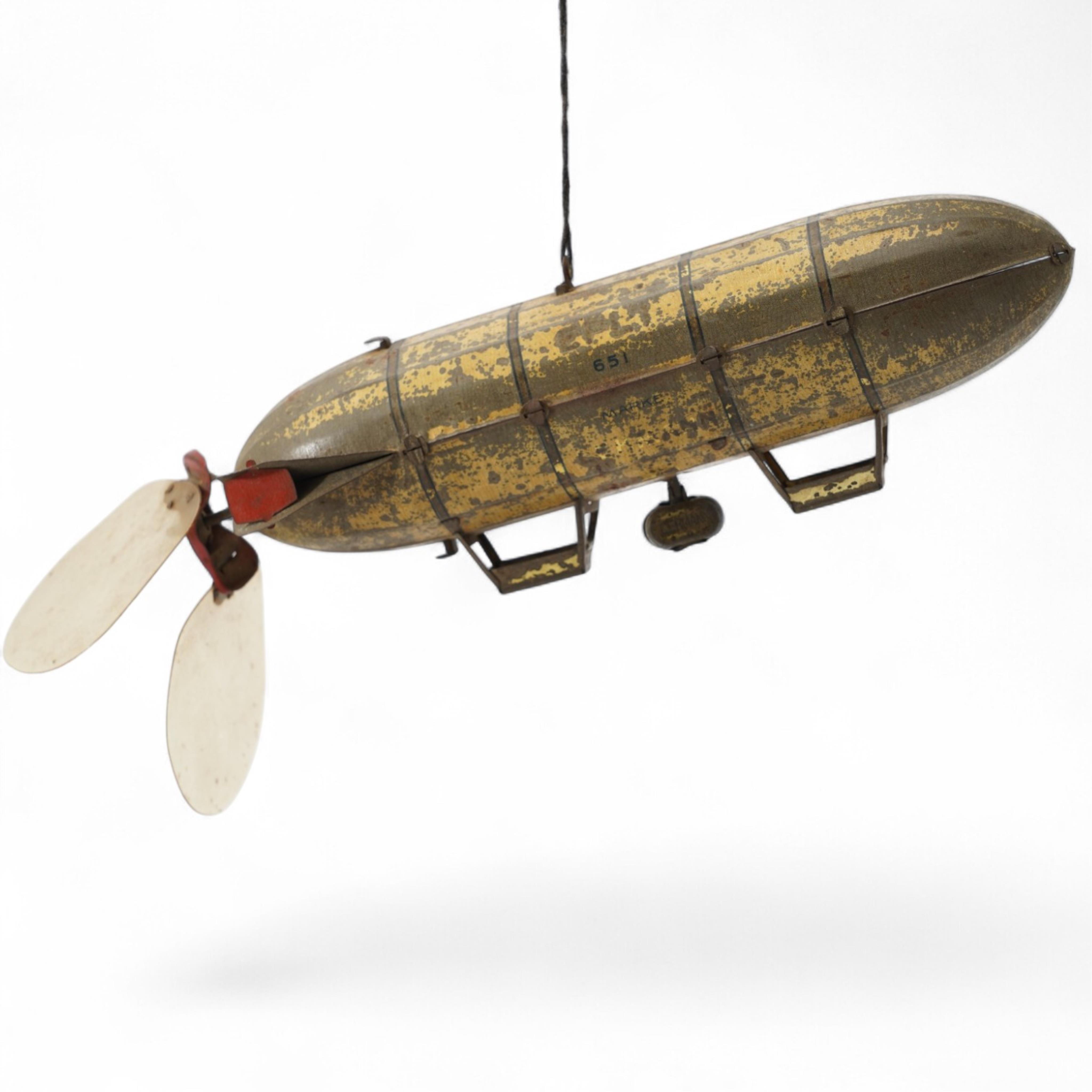 An early 20th century Lehmann tinplate clockwork EPL-1 zeppelin, 651, with rotating propellers to the rear. Condition - poor to fair, considerable losses to paint work, however clockwork motor still has some strength.